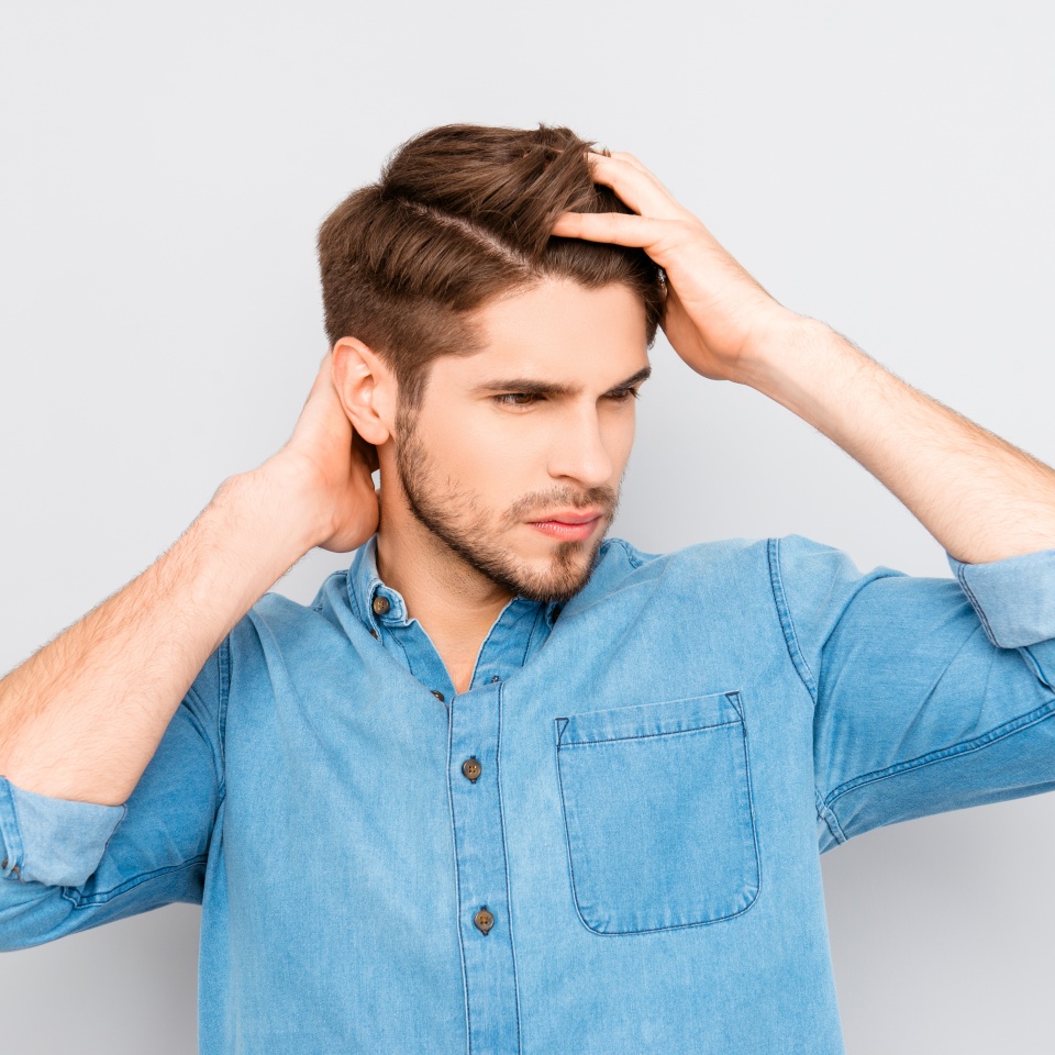 Portrait of healthy man combing his hair with fingers